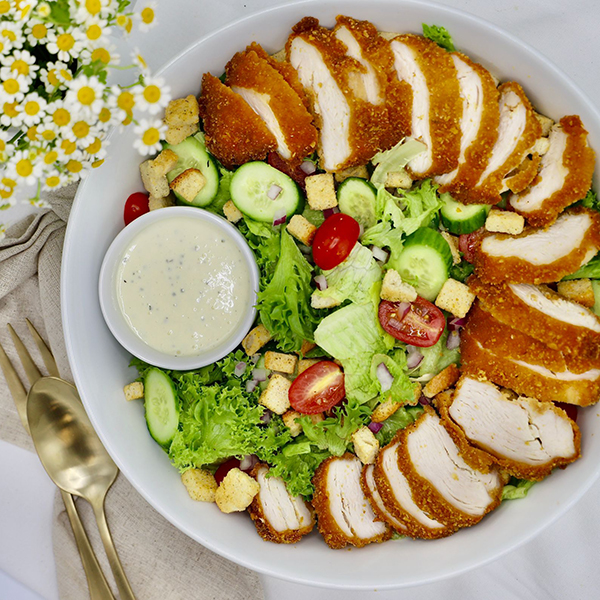 Schnitzel Caesar Salad: Caesar Salad Topped With Sliced Breaded Schnitzel - Caesar Dressing