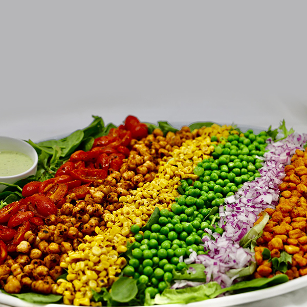 Summer Cobb Salad: Thin Sliced Romaine, Charred Grape Tomatoes, Mini Peas, Shaved Grilled Corn, Diced Red Onion, Seared Chic peas, Bbq Corn nuts - Creamy Basil Dressing